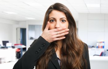 bad breath, woman hiding mouth with her hand